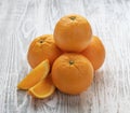 Sweet orange on a white wooden background. Farm healthy and eco-friendly fruits and vegetables. Rustic style Royalty Free Stock Photo