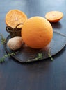 Sweet Oranges whole fruit and cut in half and ginger on a metal plate Royalty Free Stock Photo