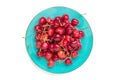 sweet organic berries in blue plate isolated on white background Top view Flat lay Summer harvest concept Royalty Free Stock Photo