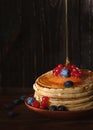 Sweet pancakes blueberry, redcurrant and honey topping. Homemade pancakes with berries and honey