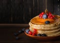 Sweet pancakes blueberry, redcurrant and honey topping. Homemade pancakes with berries and honey