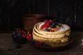 Sweet pancakes blueberry and redcurrant topping. Homemade pancakes with berries and coconut flakes