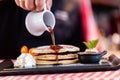 Sweet pancakes dripped with maple syrup in american restaurant