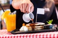 Sweet pancakes dripped with maple syrup in american restaurant Royalty Free Stock Photo