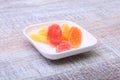 Sweet papaya dried slices in white plate on wood background. selective focus.