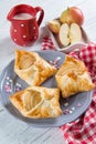 Sweet pastries in the shape of an envelope with heart filled with apples, fresh apples and milk jug