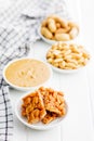Sweet peanut brittle, peanuts and peanuts butter on white table Royalty Free Stock Photo