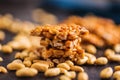 Sweet peanut brittle. Tasty peanuts in caramel on kitchen table