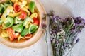 Sweet Pepper Cutting Sliced Preparation for Cooking. Raw Variety Red, Green, Yellow Sweet Peppers Slicing Chopped in Wooden Bowl Royalty Free Stock Photo