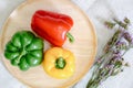 Sweet Pepper Preparation for Cooking. Raw Mix Variety Red, Green, Yellow Sweet Peppers in Wooden Bowl on Kitchen Table. Raw Royalty Free Stock Photo