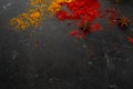 Red pepper and saffron lies on a dark stone stone table