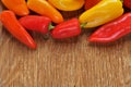 Sweet peppers of different colors on a rustic table Royalty Free Stock Photo