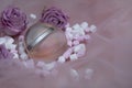 Sweet perfume on a pink background with marshmallows and flowers, roses. A wonderful delicate fragrance for women. Happy womens