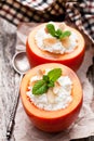 Sweet persimmons stuffed with cottage cheese and almonds on woo