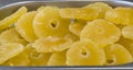 Sweet Pineapple - Dried candied pineapple rings in a full frame composition. Sweet slices of fruit in a warm yellow color under a Royalty Free Stock Photo