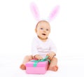 Sweet pink baby sitting in costume easter bunny with fluffy ears Royalty Free Stock Photo