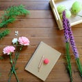 Sweet Pink and Purple flowers with notebook and pencils on wood table background Royalty Free Stock Photo