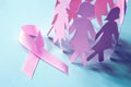 The Sweet pink ribbon shape with girl paper doll on blue background for Breast Cancer Awareness symbol to promote in october mo