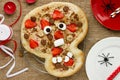 Sweet pizza in the form of funny skull to treat kids at Halloween party