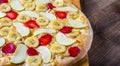 Sweet Pizza with Mozzarella cheese, apple, banana, strawberries. Fruit dessert pizza on wooden table Royalty Free Stock Photo