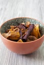 Sweet potato, beetroot and parsnip crisps chips in a patterned bowl.