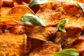 Sweet potato chips with basil as background Royalty Free Stock Photo