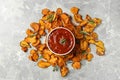 Sweet potato chips and bowl of sauce on grey background, Royalty Free Stock Photo