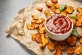 Sweet potato chips and bowl of sauce served on grey Royalty Free Stock Photo