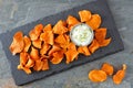 Sweet potato chips with dip, above view on slate Royalty Free Stock Photo