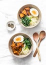 Sweet potato, couscous, spinach, egg buddha bowl on light background, top view. Vegetarian food Royalty Free Stock Photo