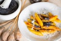 Sweet potato dumpling wedges with poppy seeds, poppy heads and mortar Royalty Free Stock Photo