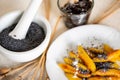 Sweet potato dumpling wedges with poppy seeds, plum jam and mortar Royalty Free Stock Photo
