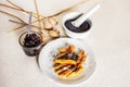 Sweet potato dumplings wedges with poppy seed, poppy heads, plum jam, mortar Royalty Free Stock Photo