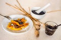 Sweet potato dumplings wedges with poppy seed, poppy heads, plum jam, mortar Royalty Free Stock Photo