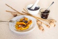 Sweet potato dumplings wedges with poppy seeds, poppy heads, plum jam, mortar Royalty Free Stock Photo