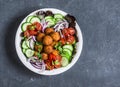 Sweet potato falafel vegetables salad bowl on dark background, top view. Vegetarian food concept Royalty Free Stock Photo