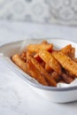 Sweet potato French fries chips in a white enamel dish bowl. Royalty Free Stock Photo