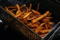 sweet potato french fries cooking in a deep fat fryer, fast food concept Royalty Free Stock Photo