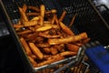 sweet potato french fries cooking in a deep fryer Royalty Free Stock Photo