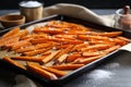 sweet potato fries on a baking sheet fresh from the oven