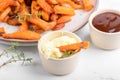 Sweet potato fries in a bowl with mayo sauce, homemade roasted pumpkin in the oven, close up Royalty Free Stock Photo