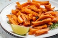 Sweet potato fries with herbs on dark background. Long banner format. top view Royalty Free Stock Photo