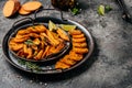 Sweet potato fries with herbs on dark background. Long banner format. top view Royalty Free Stock Photo