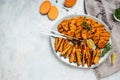 Sweet potato fries with herbs on dark background. Long banner format. top view Royalty Free Stock Photo