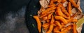 Sweet potato fries with herbs on dark background. Long banner format. top view Royalty Free Stock Photo