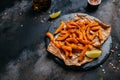 Sweet potato fries with herbs on dark background. Long banner format. top view Royalty Free Stock Photo