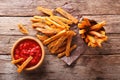 Sweet potato fries with herbs and ketchup close-up on the table. Royalty Free Stock Photo