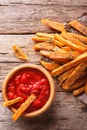 Sweet potato fries with herbs and ketchup close-up on the table. Royalty Free Stock Photo