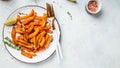 Sweet potato fries with herbs on light background. Long banner format. top view Royalty Free Stock Photo