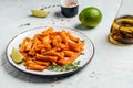 Sweet potato fries with lime and herbs on light background. top view Royalty Free Stock Photo